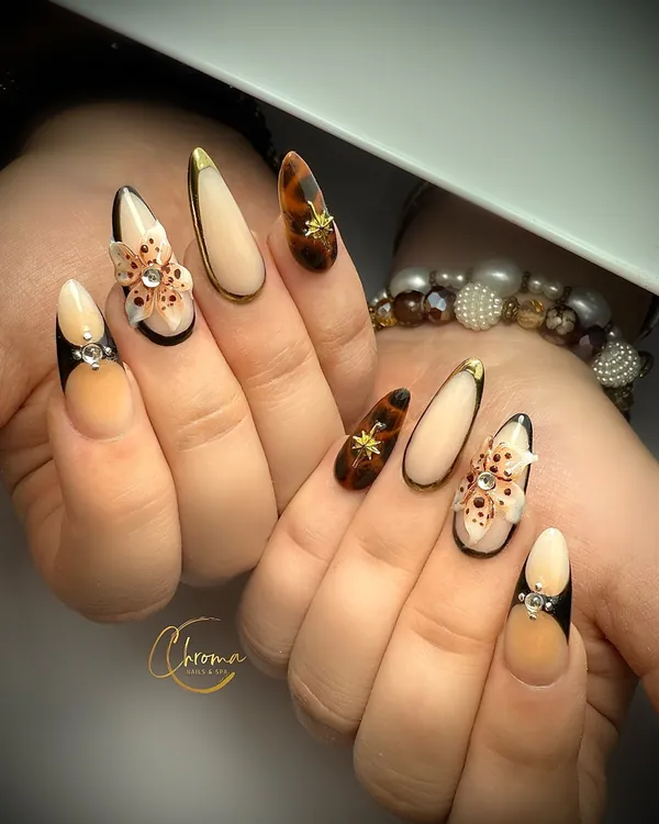Caramel and black French tips with ornate gold detailing