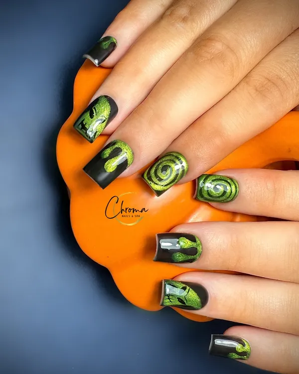 Matte black square nails with glowing green slime drips and hypnotic swirls